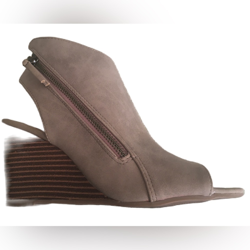 Beige open toe zip up wedge sandal.